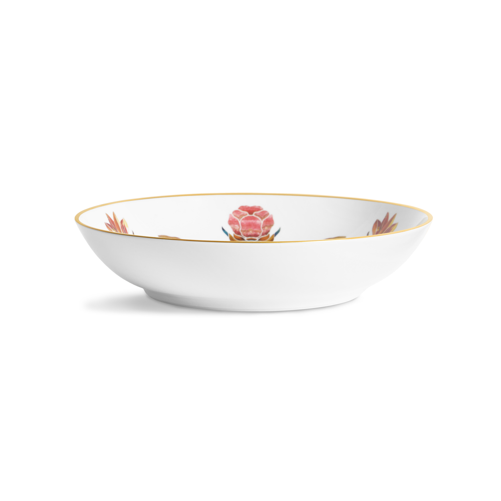 A white porcelain bowl with painted flowers on the inside and a gold rim