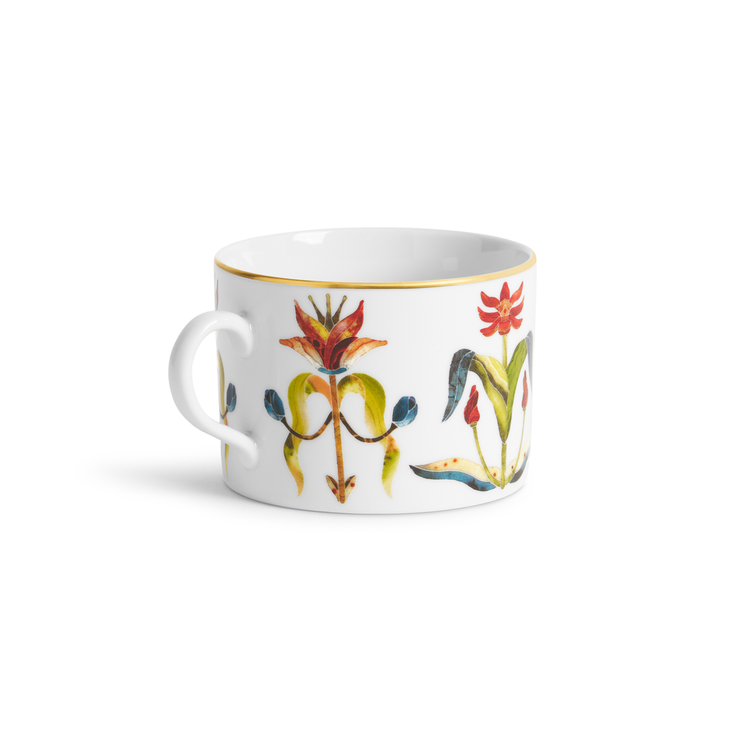 A white teacup with painted floral designs and a gold rim