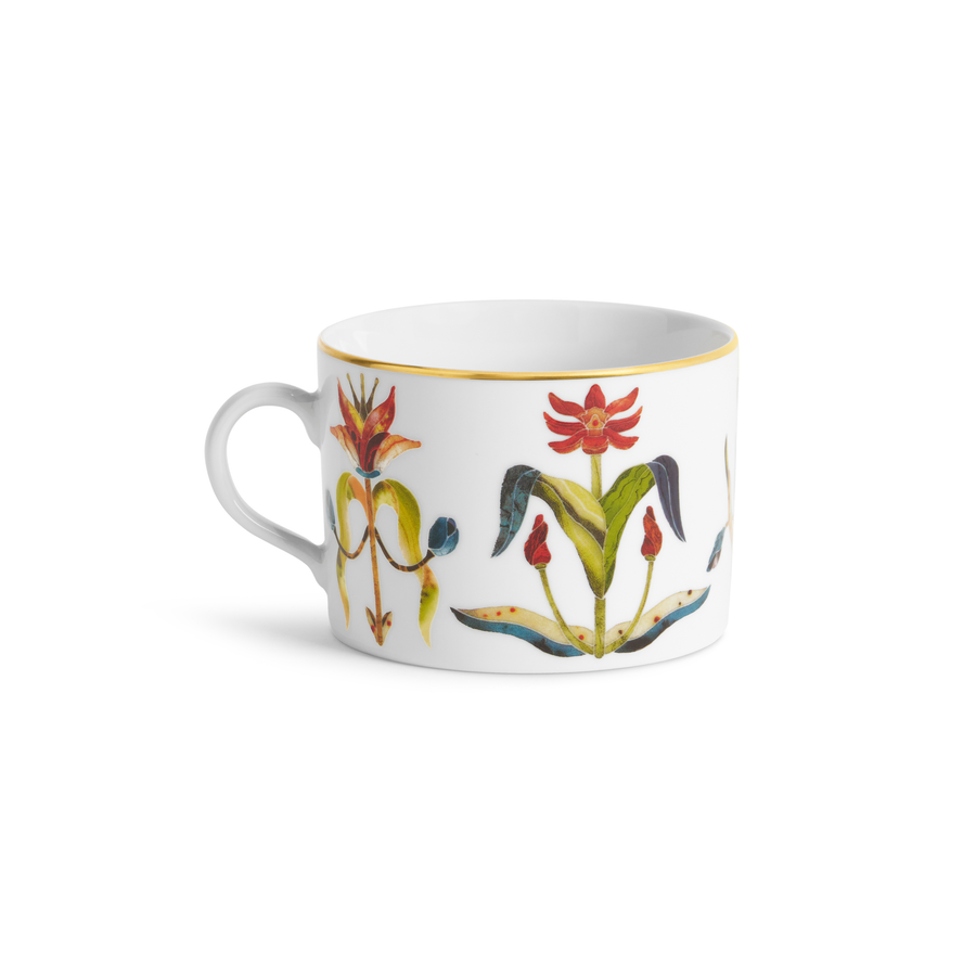 A white teacup with floral painted designs and a gold rim
