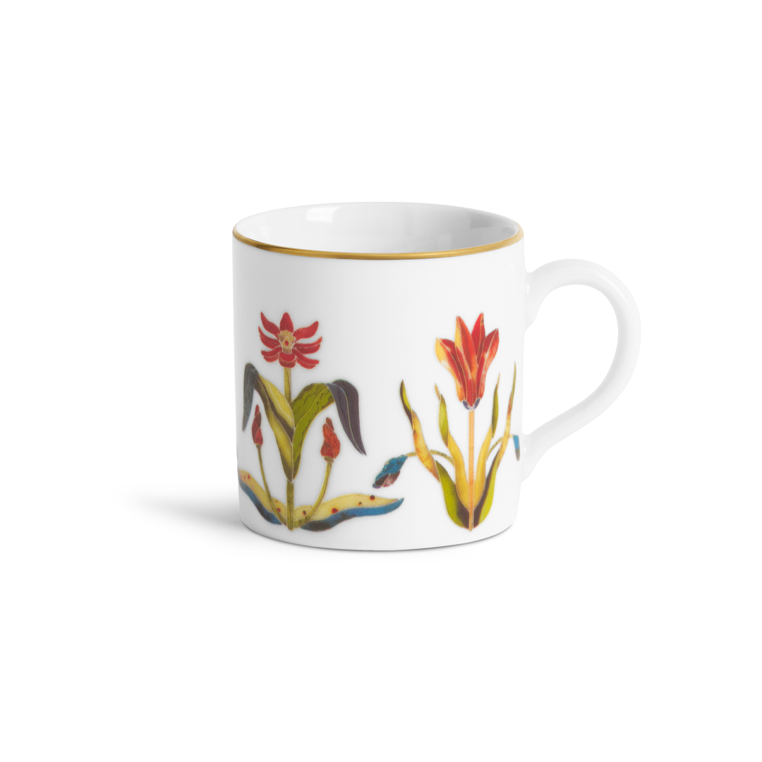 A white teacup with  floral design and a gold rim