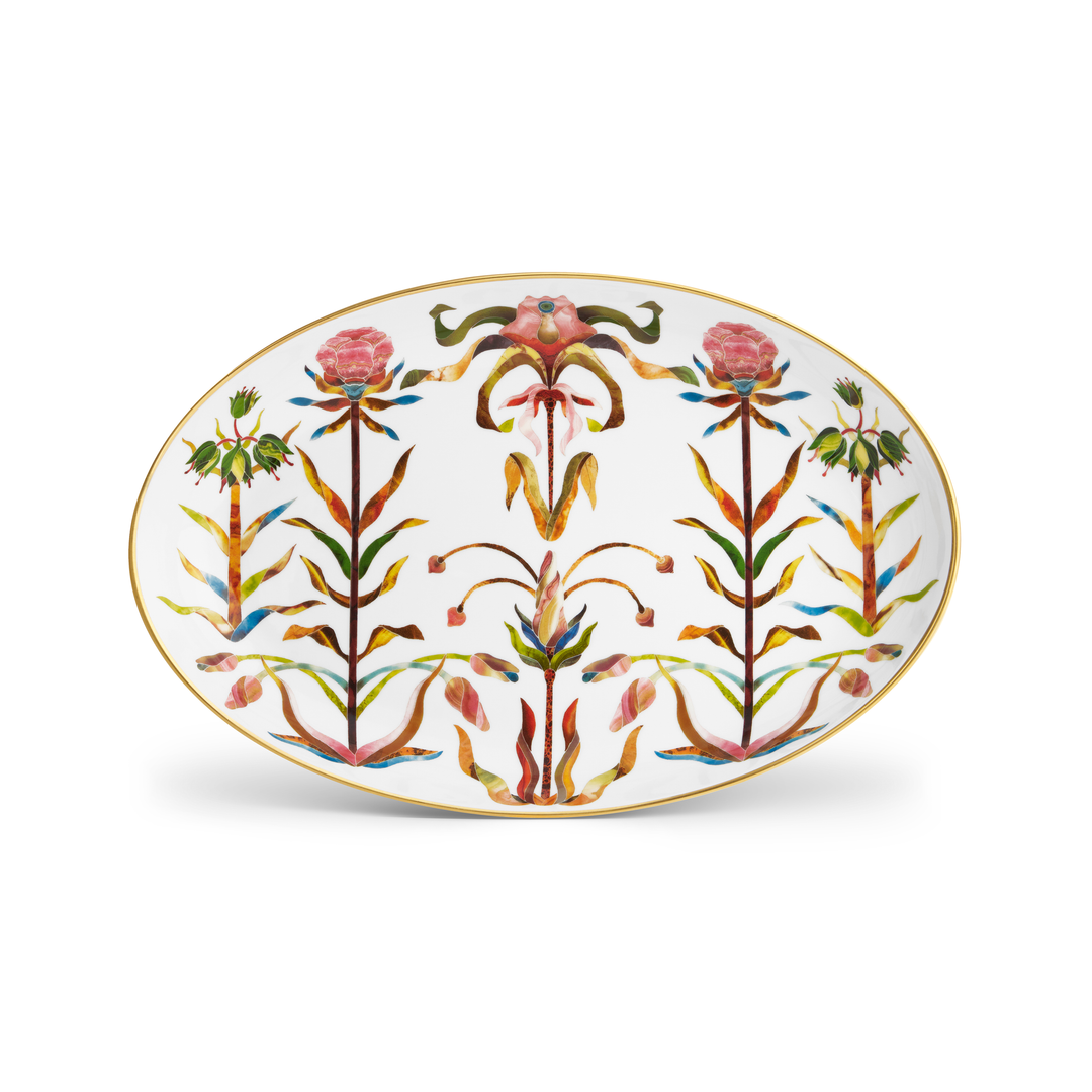 A porcelain oval platter with a painted floral pattern and a gold rim