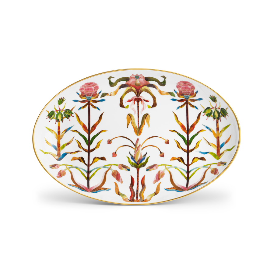 A porcelain oval platter with a painted floral pattern and a gold rim