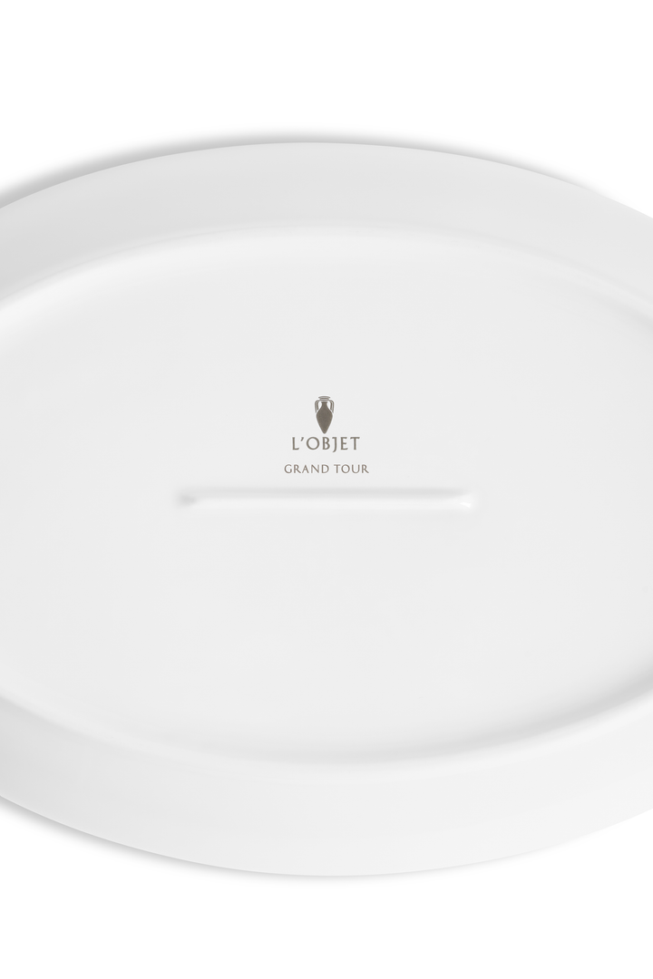 The bottom of a porcelain saucer with the L'Objet logo and "grand tour" imprinted 