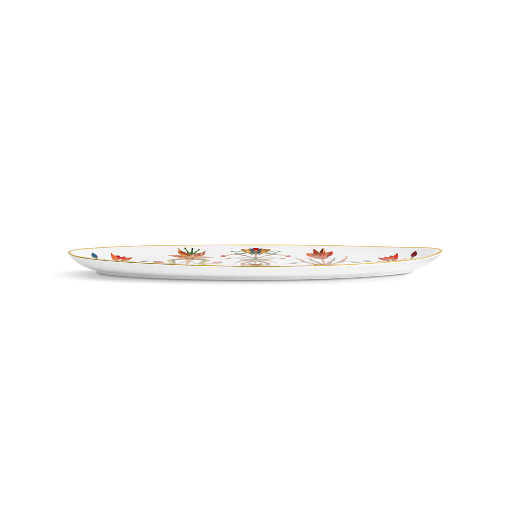 A side view of a white porcelain platter with a gold rim and painted flowers