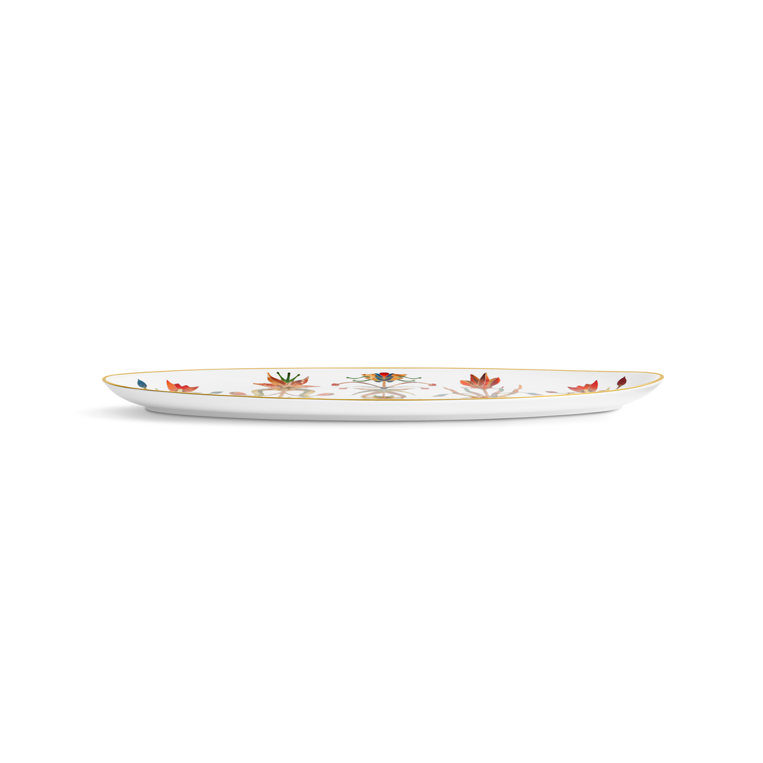 A side view of a white porcelain platter with a gold rim and painted flowers