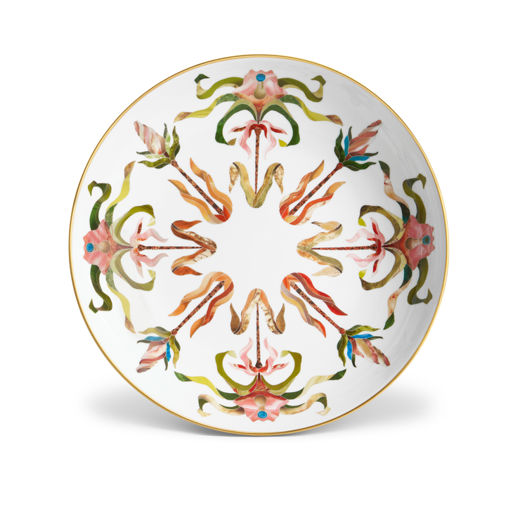 A white porcelain dish with floral motifs painted and a gold rim