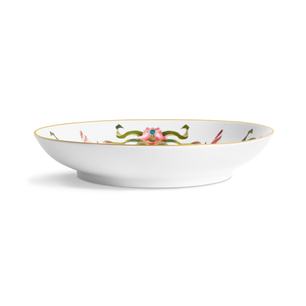 A side view of a porcelain bowl with painted floral patterns on the inside and a gold rim