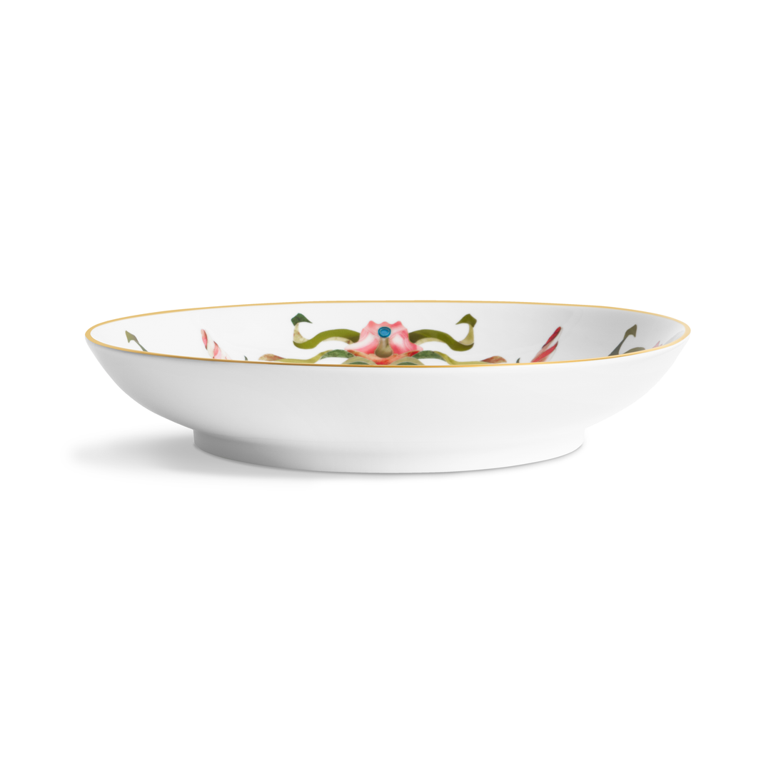 A side view of a porcelain bowl with painted floral patterns on the inside and a gold rim