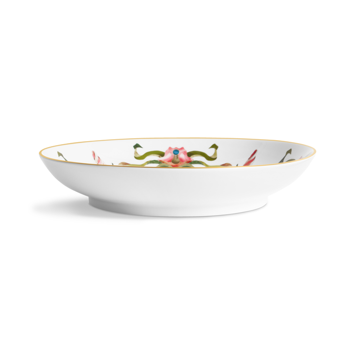 A side view of a porcelain bowl with painted floral patterns on the inside and a gold rim