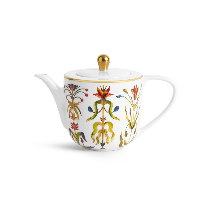 A white porcelain teapot with painted florals and gold accents