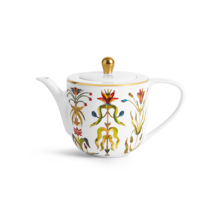 A white porcelain teapot with painted florals and gold accents