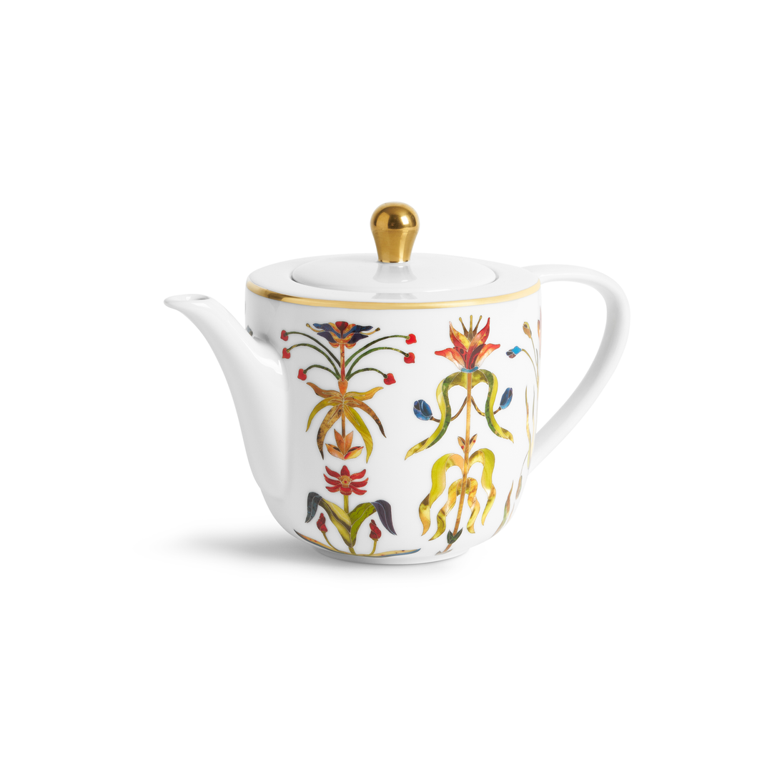 A white porcelain teapot with painted floral motifs and gold accents