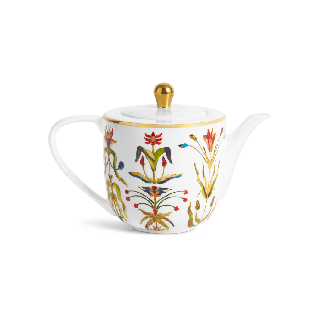 A porcelain teapot painted with floral motifs and a gold rim and knob on hte lid