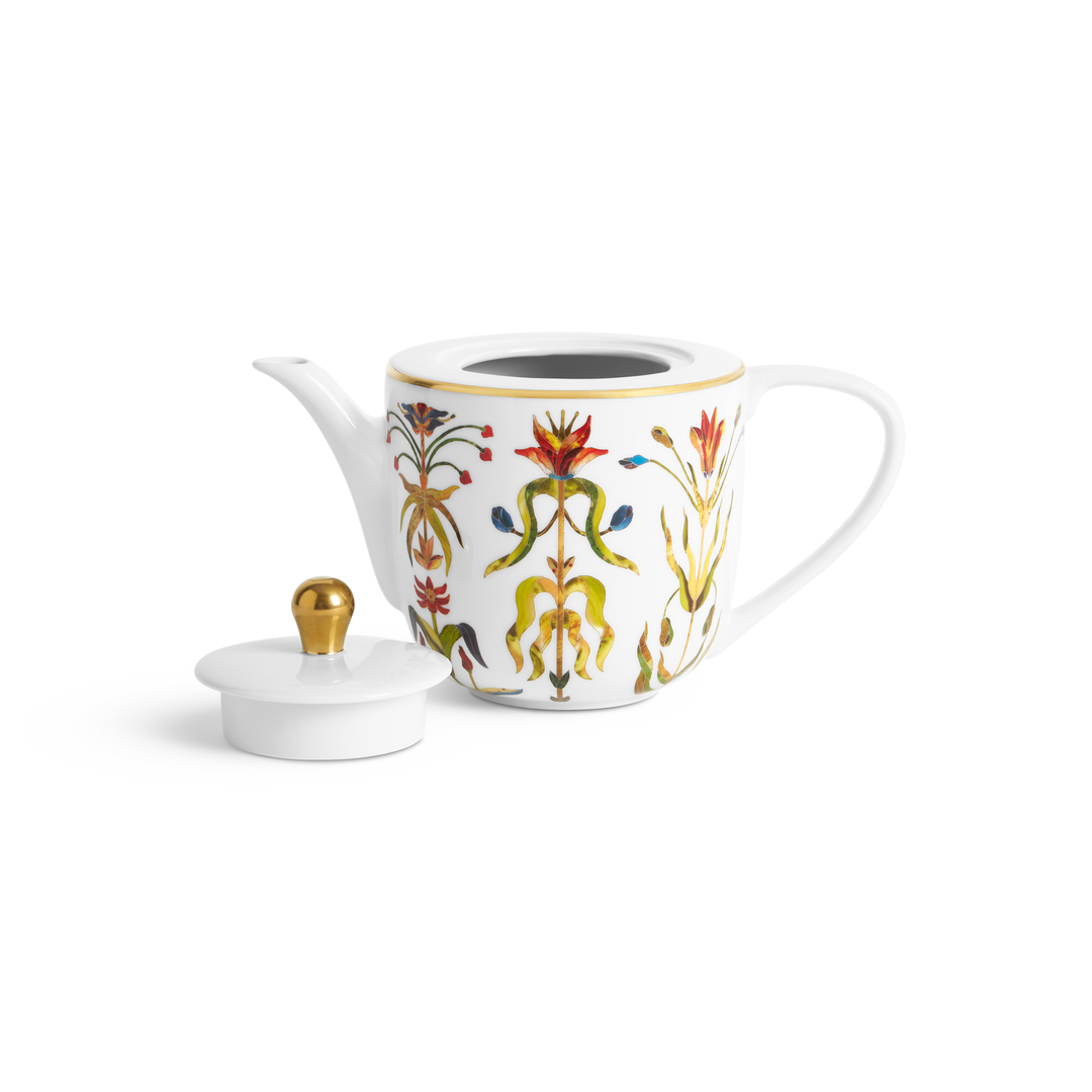 A white porcelain teapot with painter flowers and a gold trim around the top nest to its lid with has a gold knob