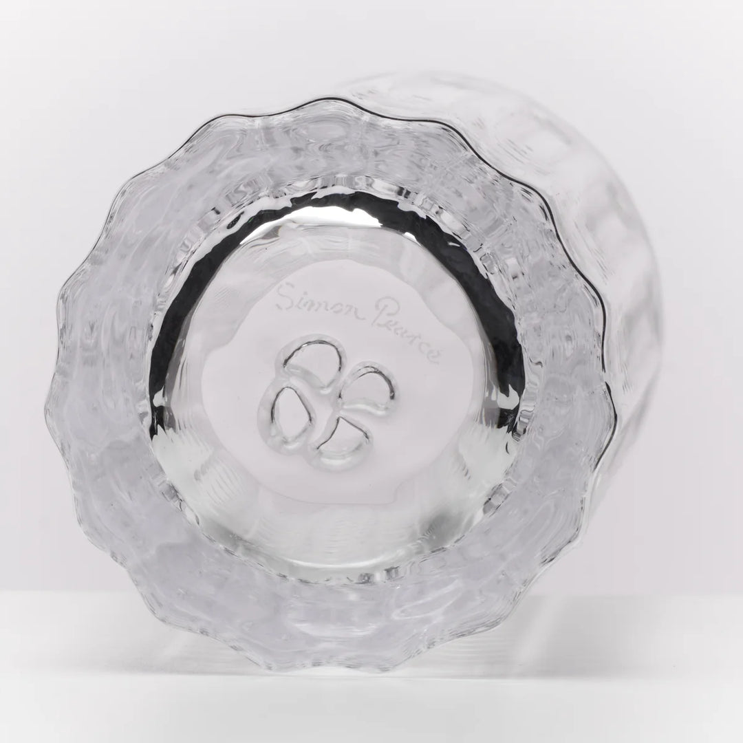 A clear textured glass bowl with a scalloped rim, photographed from a top-down angle on a white background. The brand name 'Simon Pearce' is etched in the center.