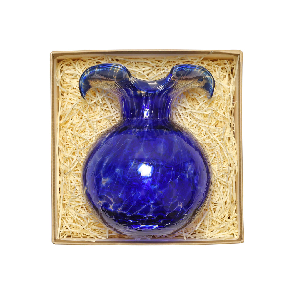 Blue glass vase in a decorative box with straw padding