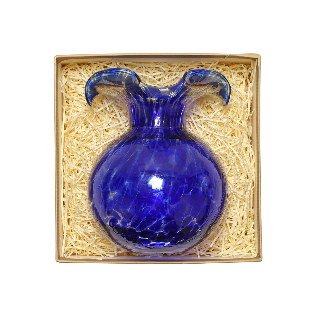 Blue glass vase in a decorative box with straw padding