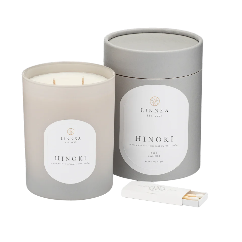 LINNEA Hinoki candle in a gray container with a matchbox