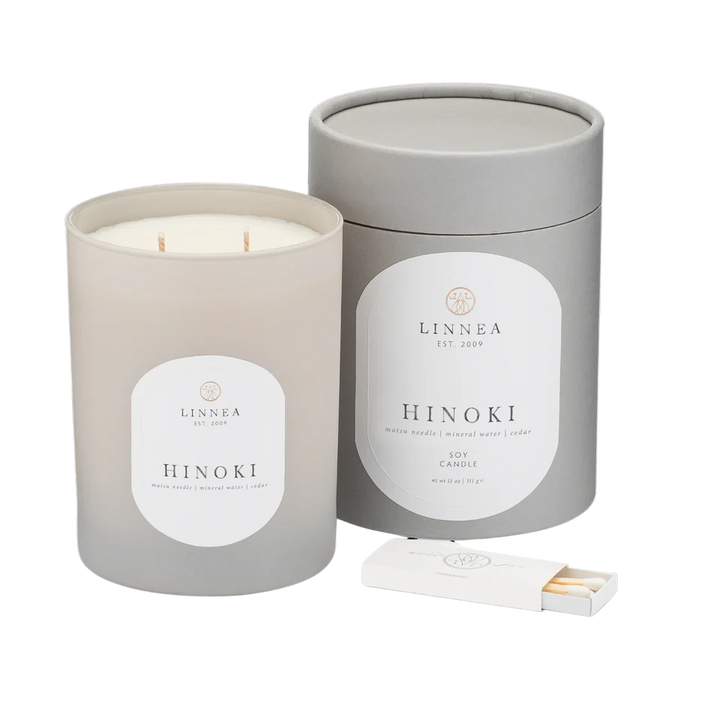 LINNEA Hinoki candle in a gray container with a matchbox