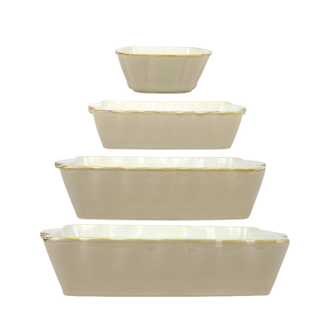 Set of four beige ceramic bowls on a white background
