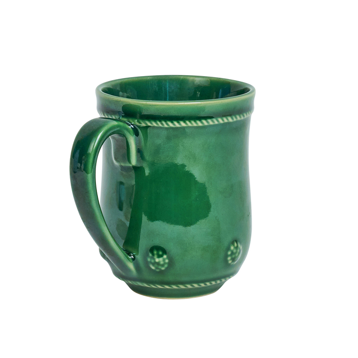 Green ceramic mug with decorative patterns on a white background