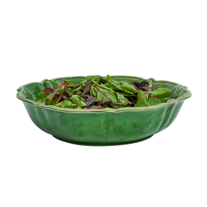 Green ceramic bowl filled with leafy greens 