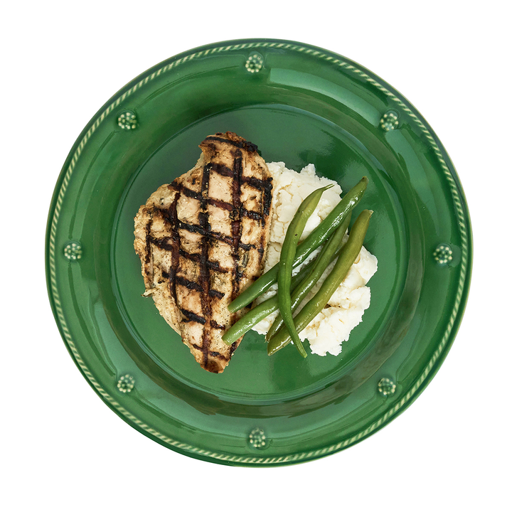Green plate with grilled chicken, mashed potatoes, and green beans