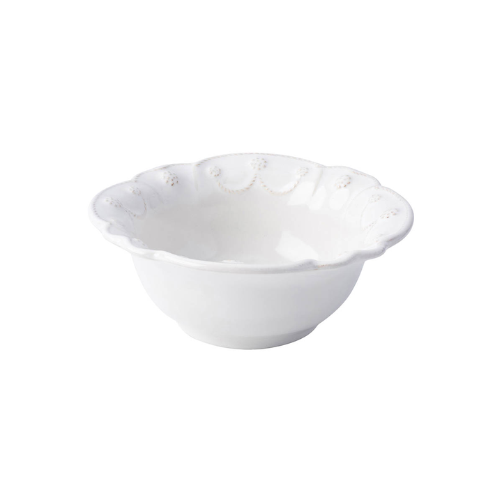 A white bowl with an ornate threaded designe with raspberry motifs stamped along the edge