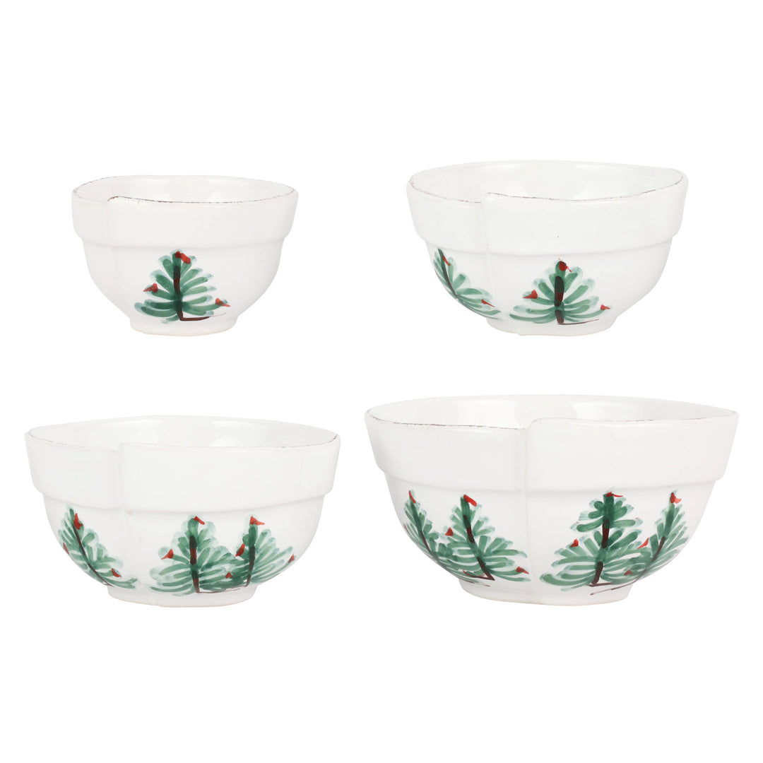 Set of four white bowls with Christmas tree design on a white background