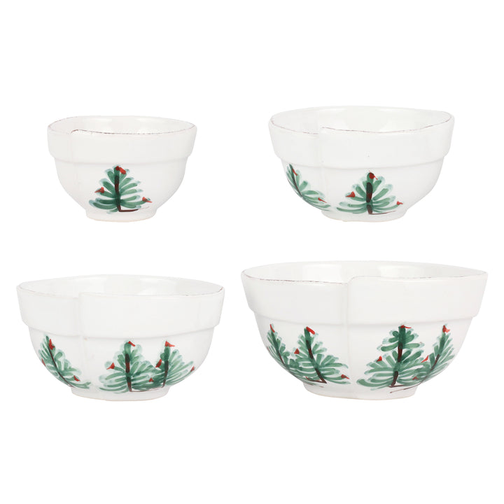 Set of four white bowls with Christmas tree design on a white background