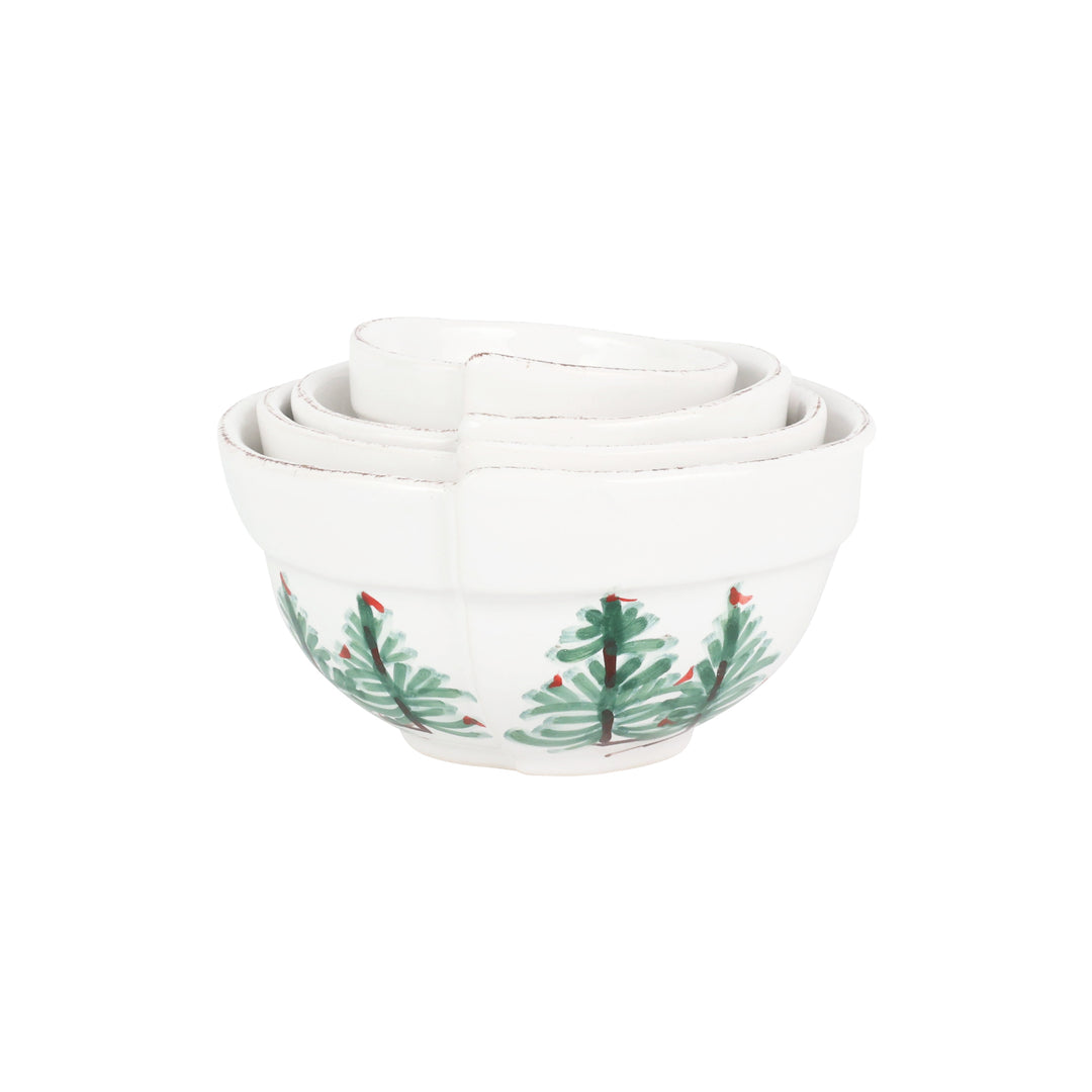 Set of four white bowls with Christmas tree design on a white background