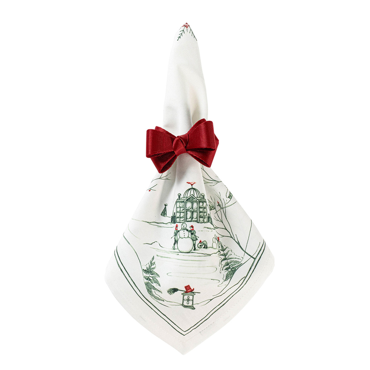 Napkin with Christmas design and red bow napkin ring on a white background