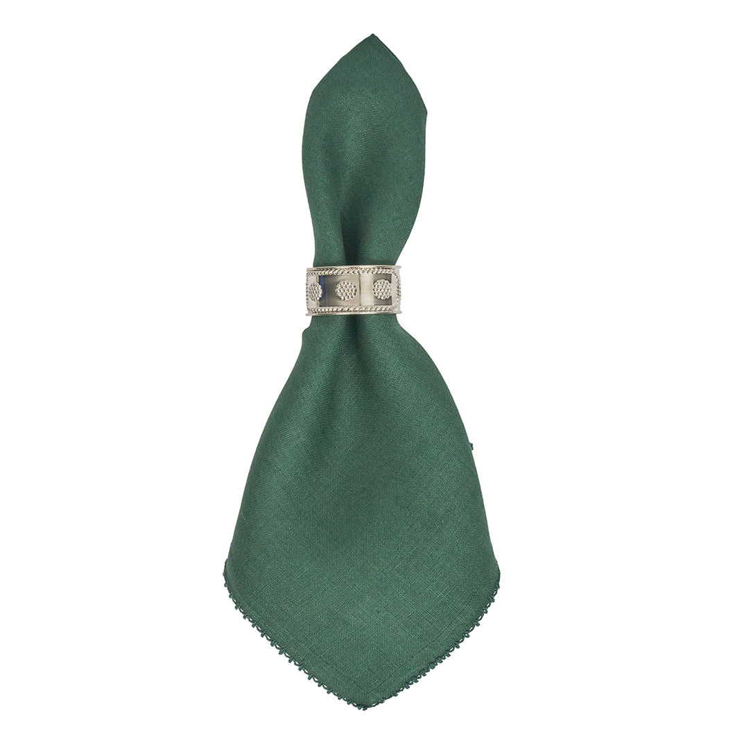 Green napkin folded into a triangle shape with a decorative silver ring