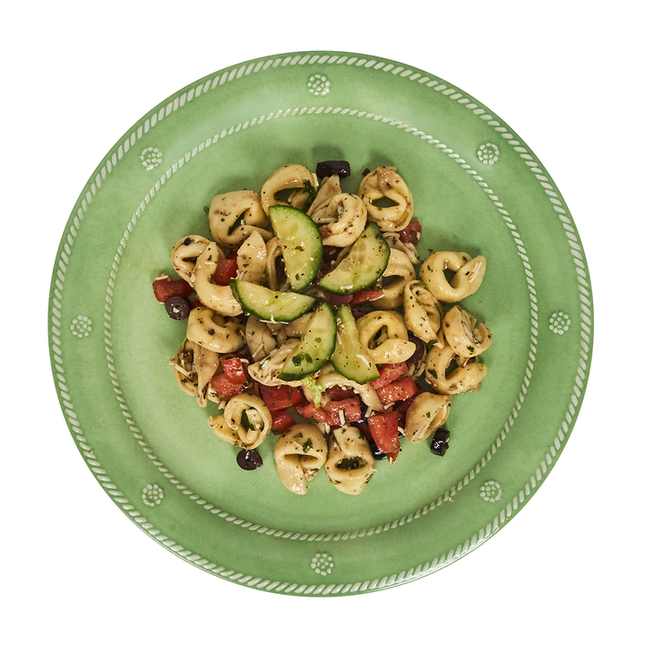 Green plate with pasta salad 