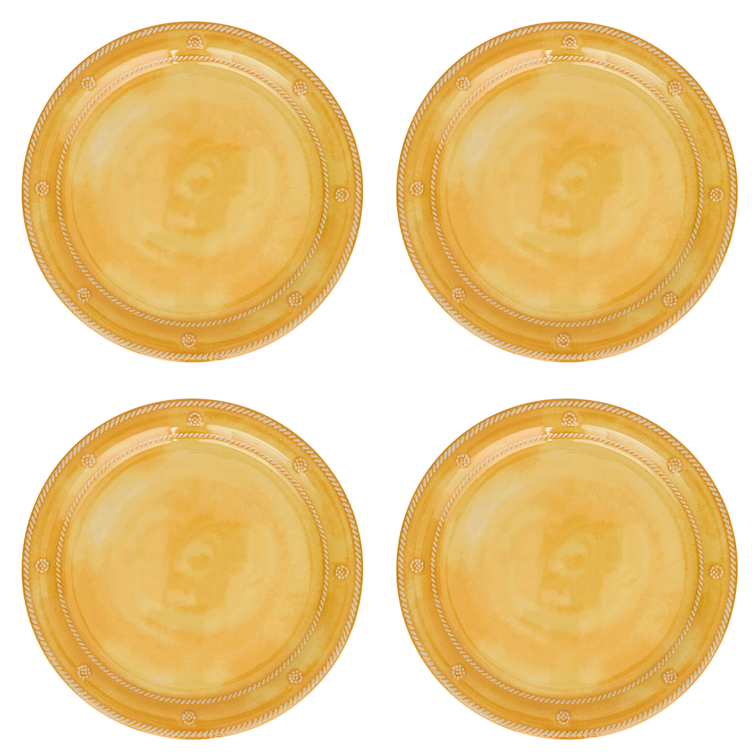 Four round gold plastic plates arranged in a 2x2 grid