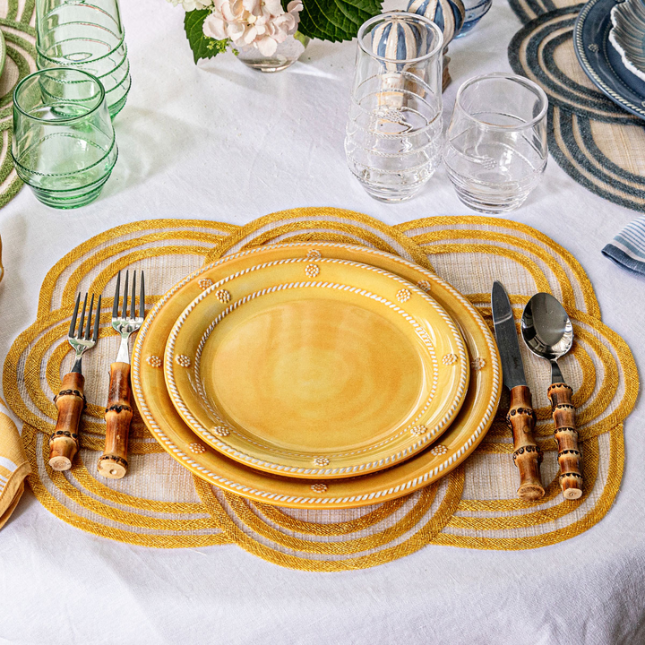 Yellow dinnerware set on a table with placemats and cutlery