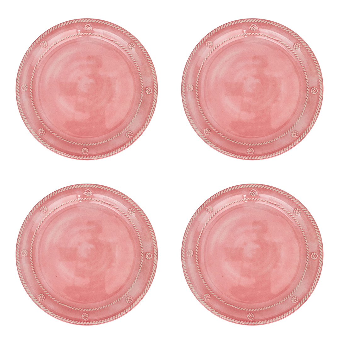 Four round pink plates arranged in a 2x2 grid on a plain white background. Each plate has a rope-style rim and small decorative motifs near the edge.