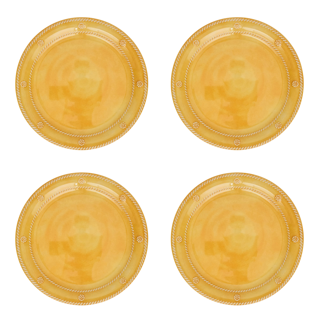 Four round gold plastic plates arranged in a 2x2 grid