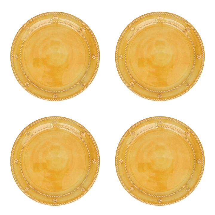 Four round gold plastic plates arranged in a 2x2 grid
