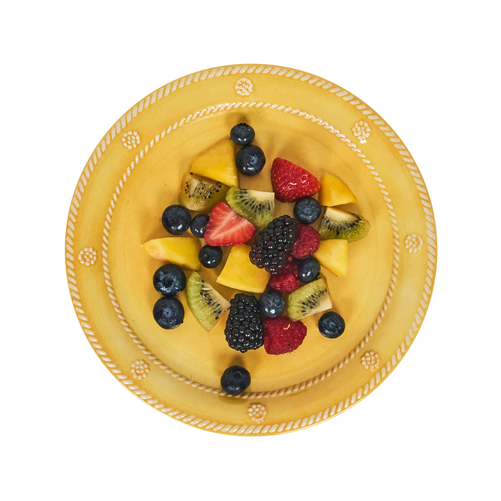Fruit salad on a yellow plate with decorative edge