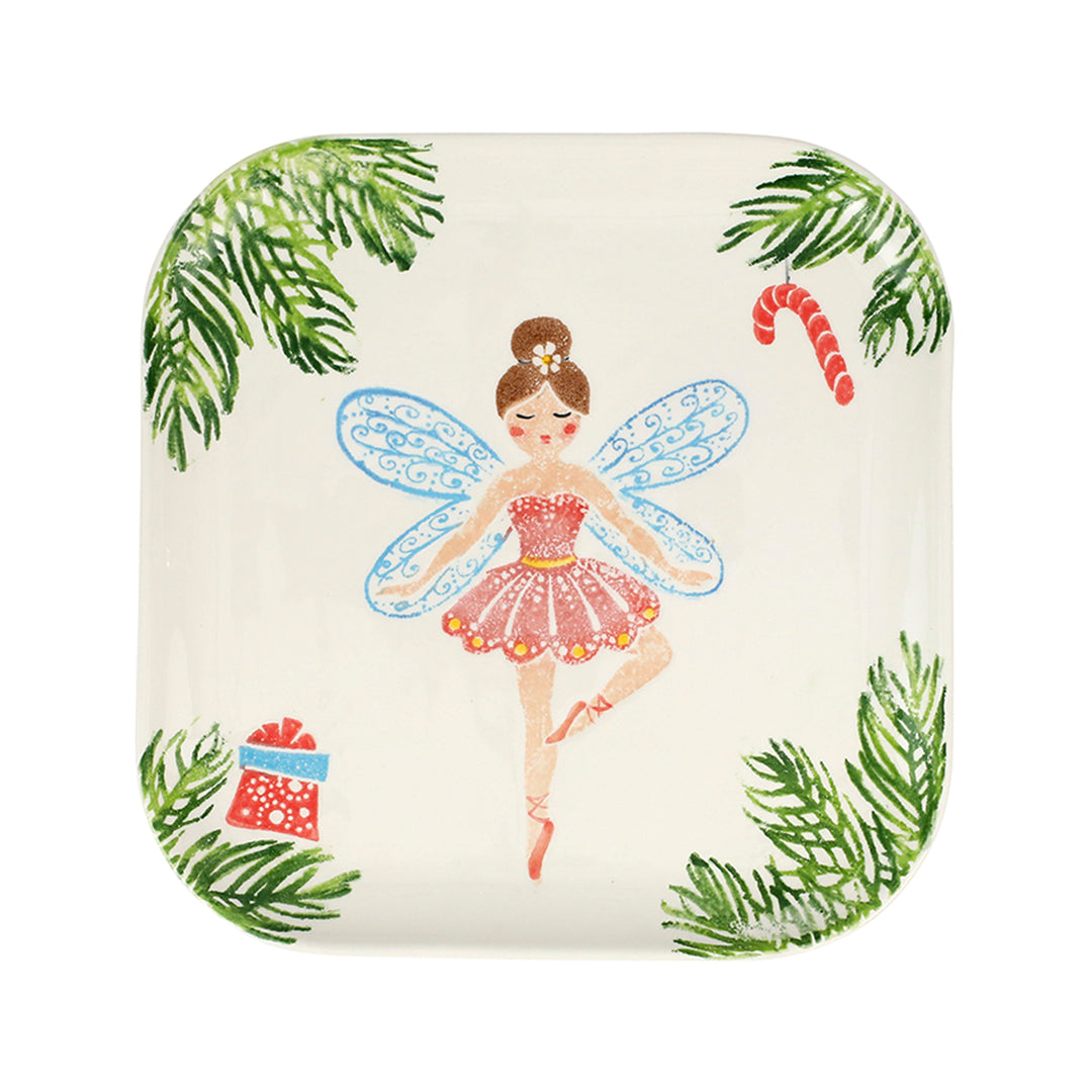 Square plate with a sugar plum fairy ballerina design surrounded by pine fronds and candy canes on a white background