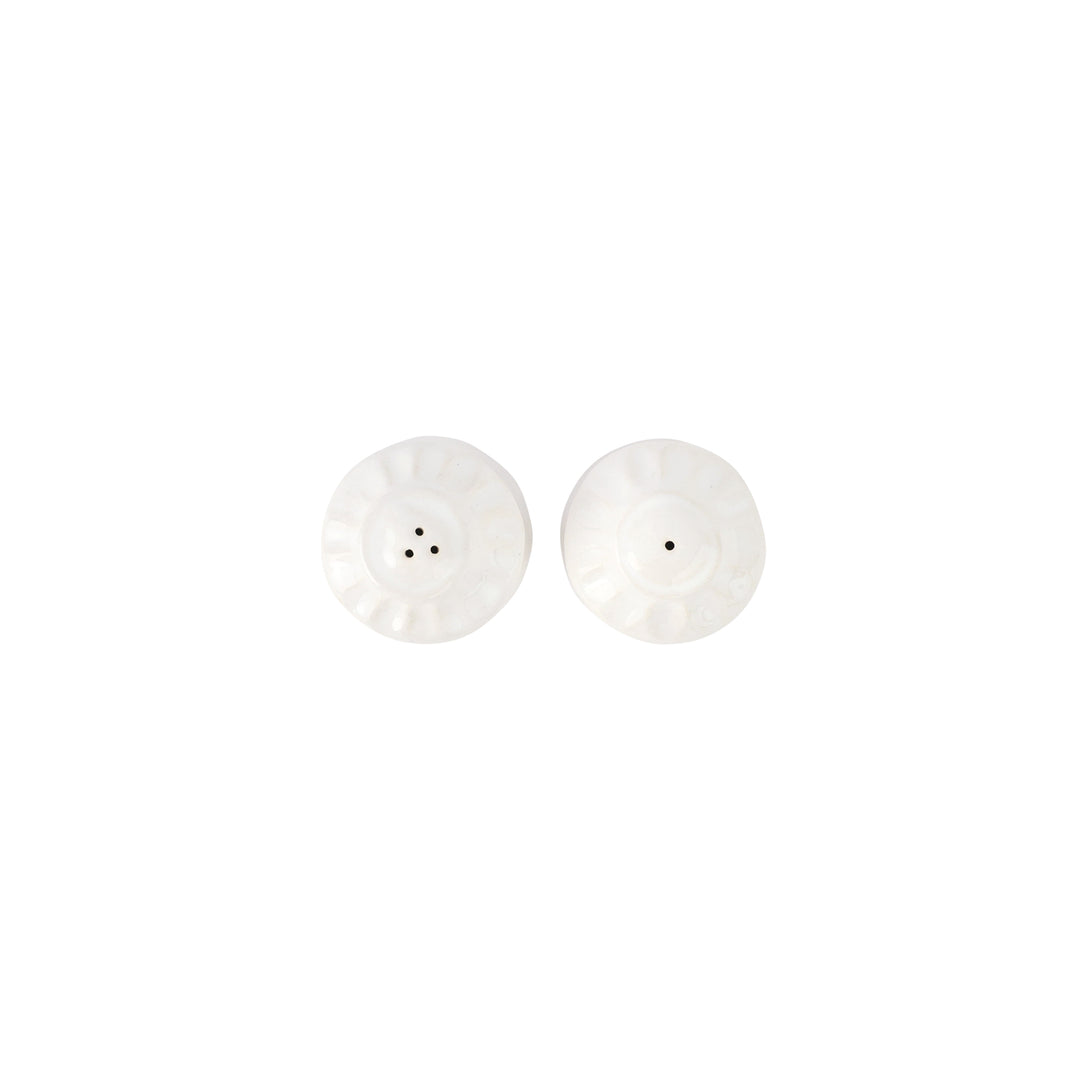 The tops of white salt and pepper shakers