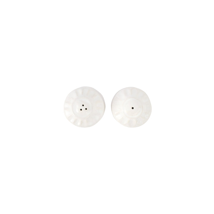 The tops of white salt and pepper shakers