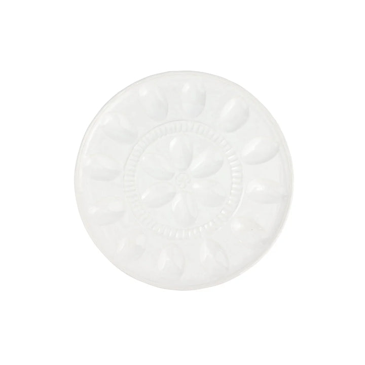 A round white ceramic plate with a raised floral pattern in the center and petal-like indentations around the rim, shown on a plain white background.