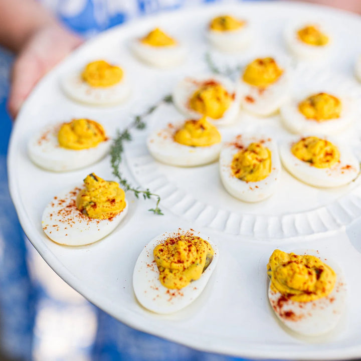 Deviled eggs on a white plate with a blurred background