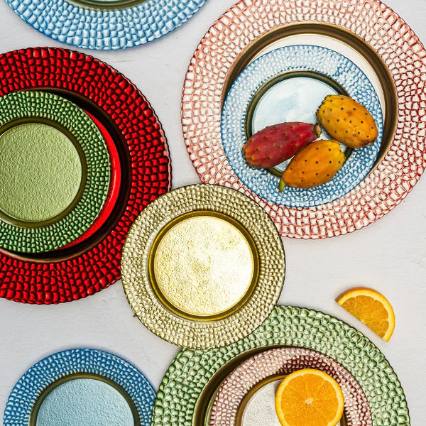 Colorful and gold textured plates with oranges and prickly pears