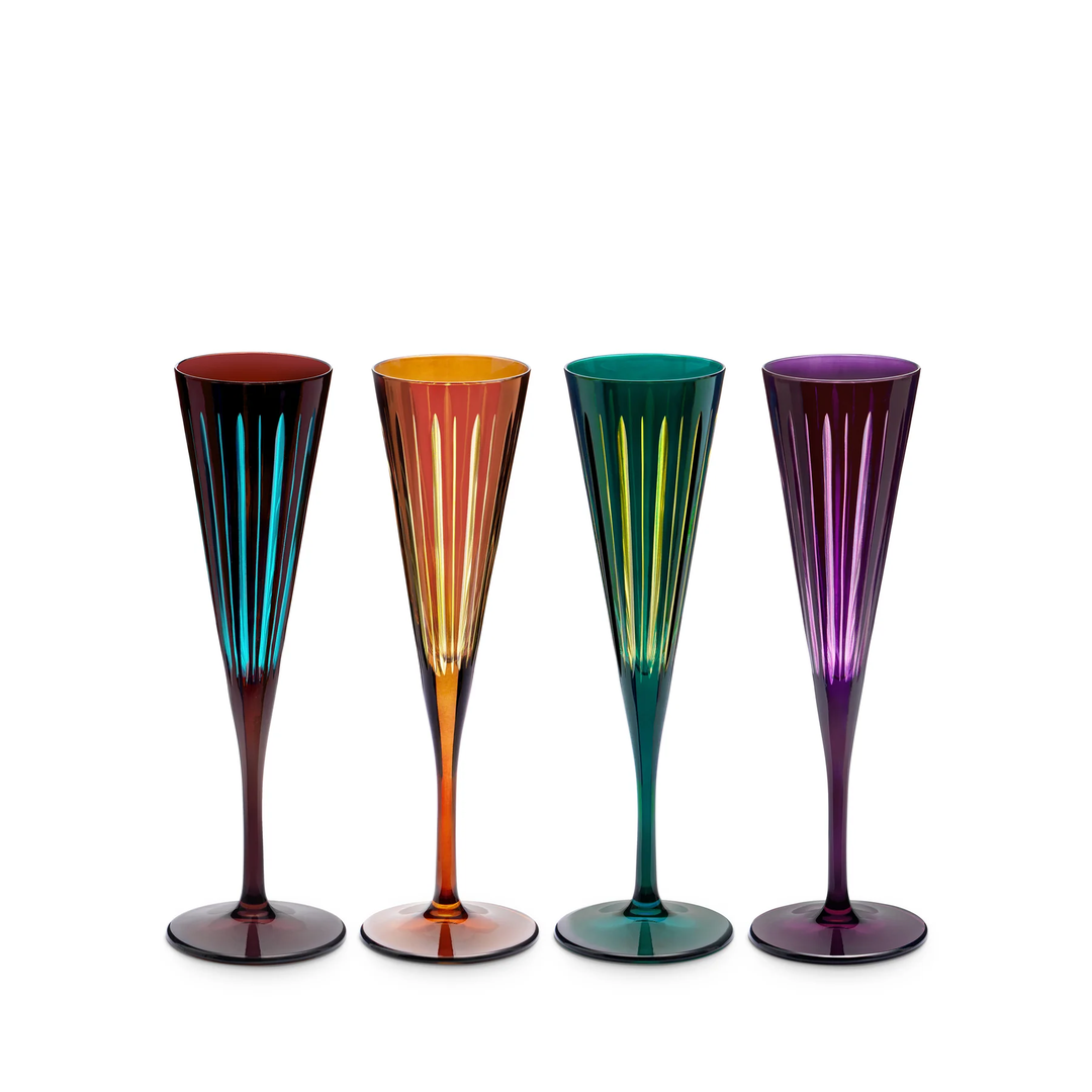 Four colorful champagne flutes on a white background