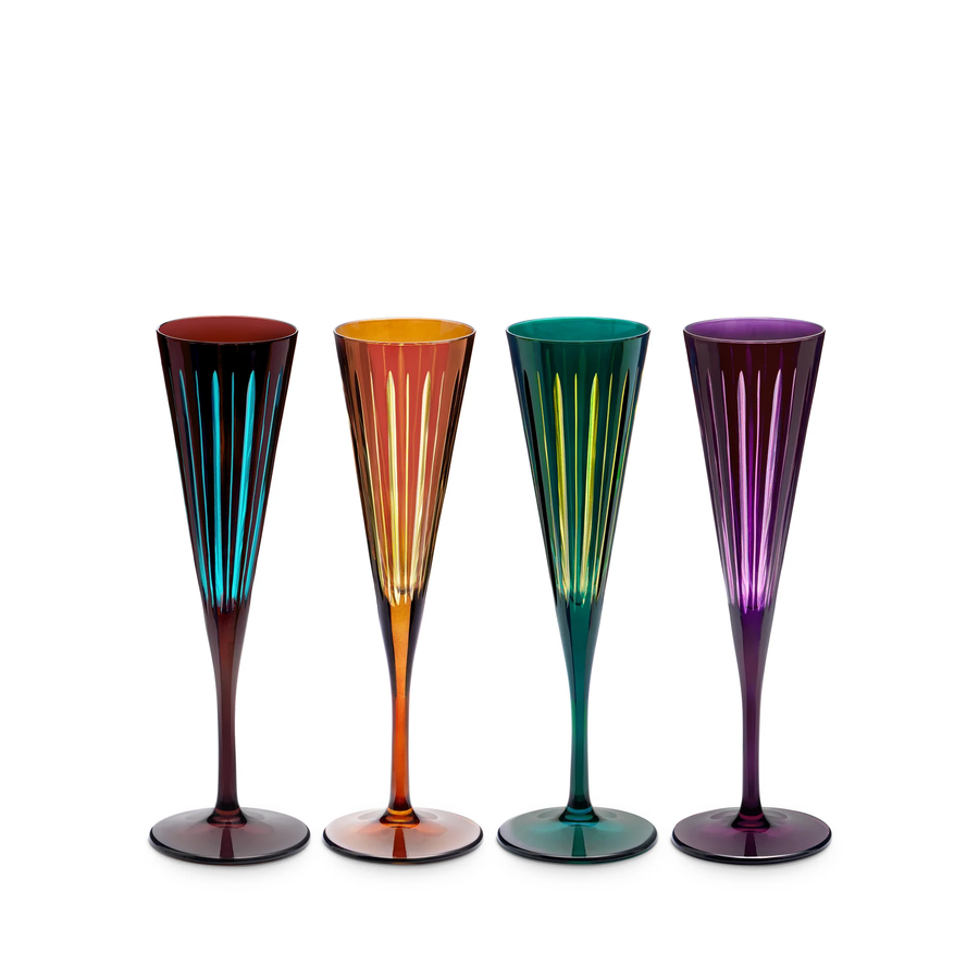 Four colorful champagne flutes on a white background