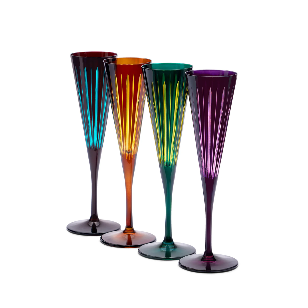 Four colorful champagne flutes on a white background