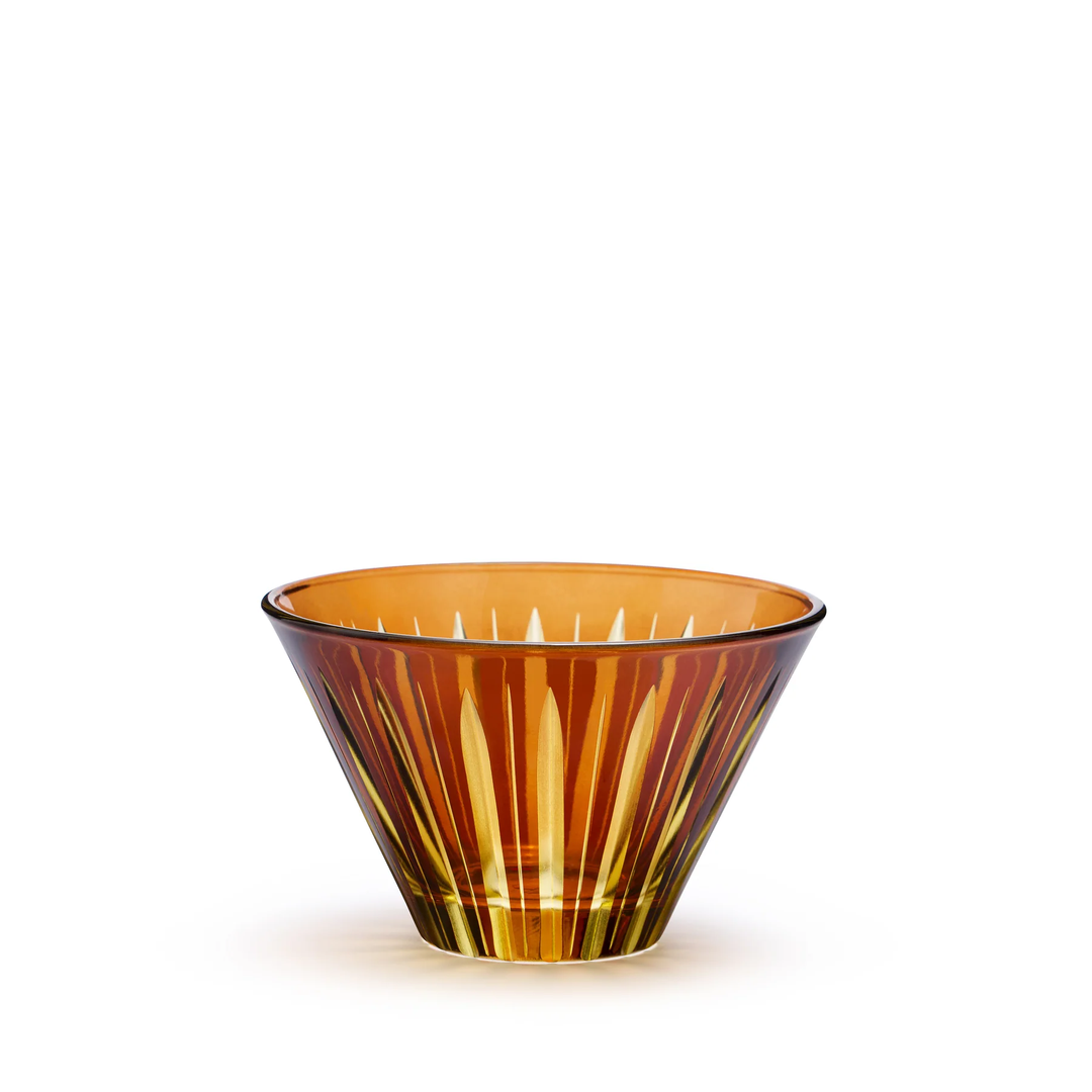 Decorative amber glass condiment cup with cut stripes on a white background